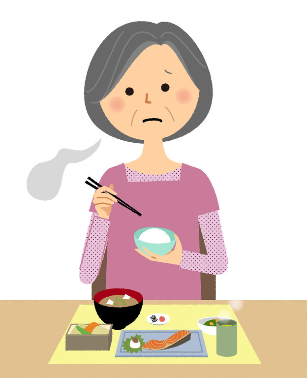 Older woman looking tired as she eats fish and rice